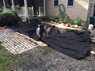 Here I am laying the underlayment to protect the underside of the liner from being punctured. 